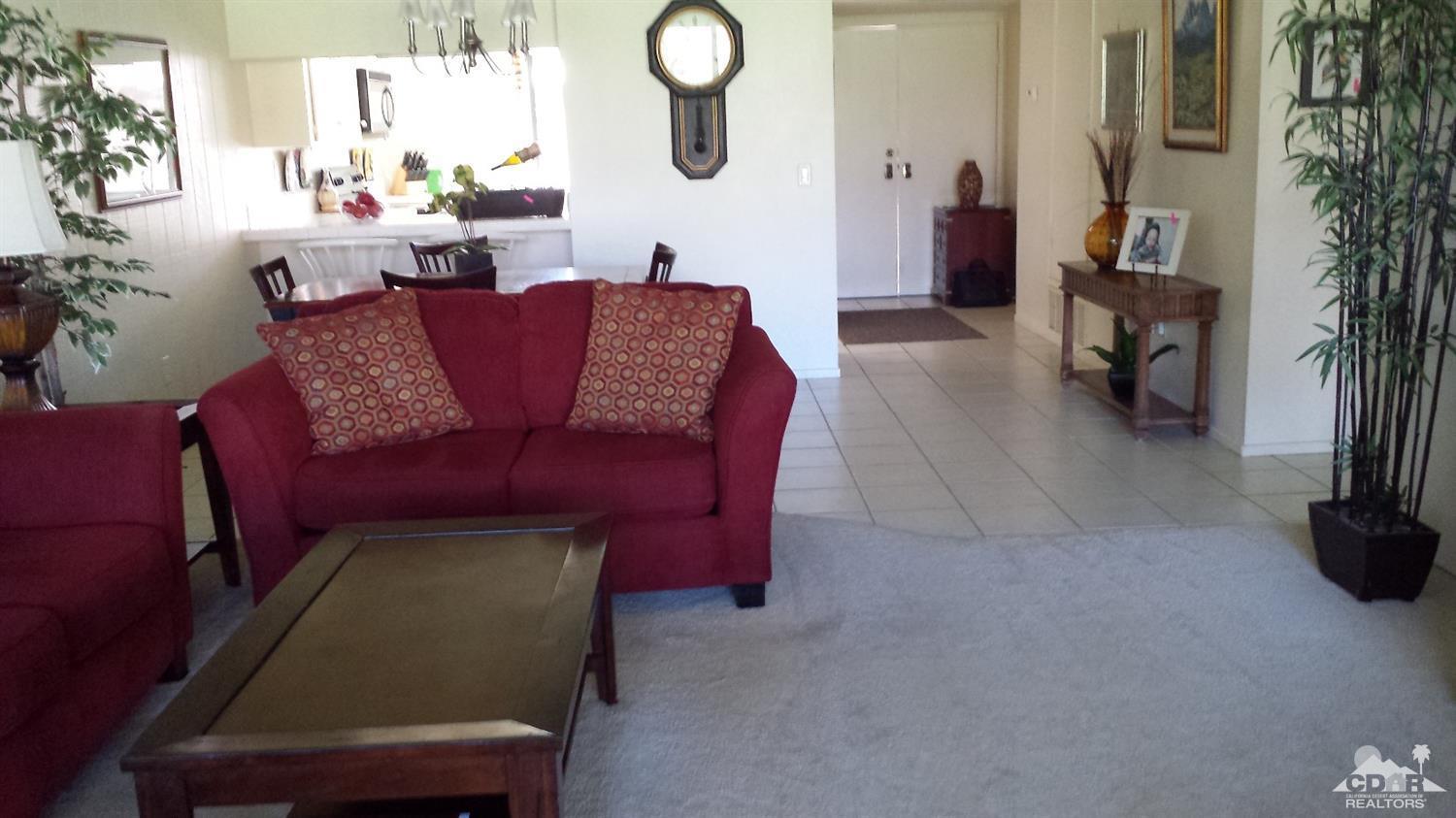 19 La Ronda Drive Rancho Mirage, CA 92270 - Photo 10 of 11 a view of a livingroom with furniture and a potted plant