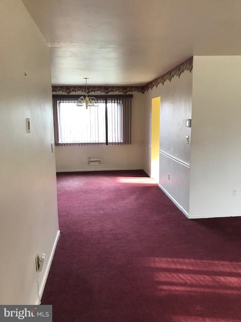 1419 Hallwood Road Baltimore, MD 21228 - Photo 2 of 14 wooden floor in an empty room with a window