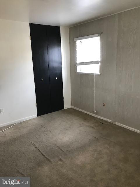 1419 Hallwood Road Baltimore, MD 21228 - Photo 6 of 14 an empty room with windows and closet
