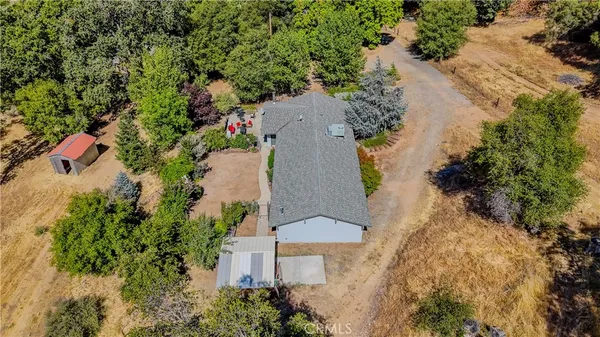 an aerial view of a house with a yard and lake view