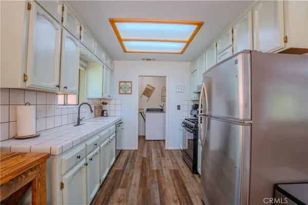 a kitchen with a refrigerator a sink and dishwasher