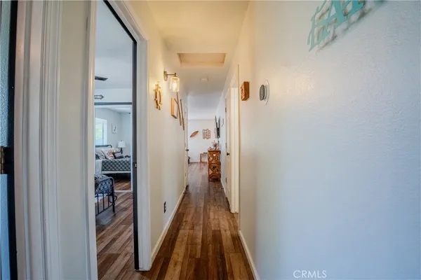 a view of a hallway with a livingroom and a bathroom with sink
