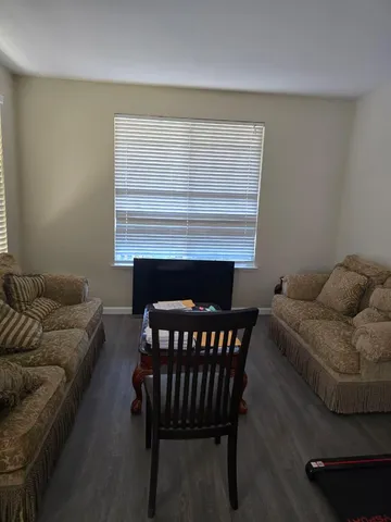 a living room with furniture a fireplace and a wooden floor