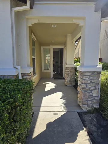 a front view of a house with a garden and yard