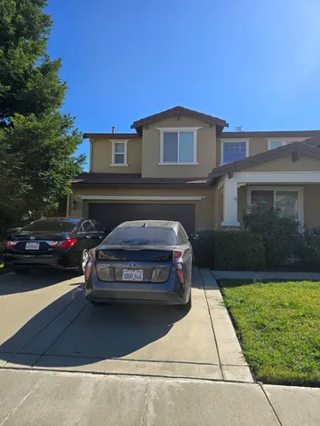a view of a car parked in front of a house