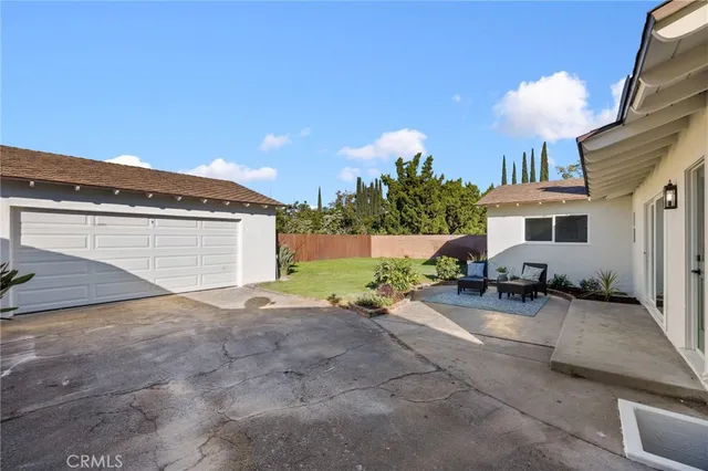 a view of a backyard with plants and a garden