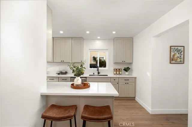 a kitchen with a sink cabinets and window