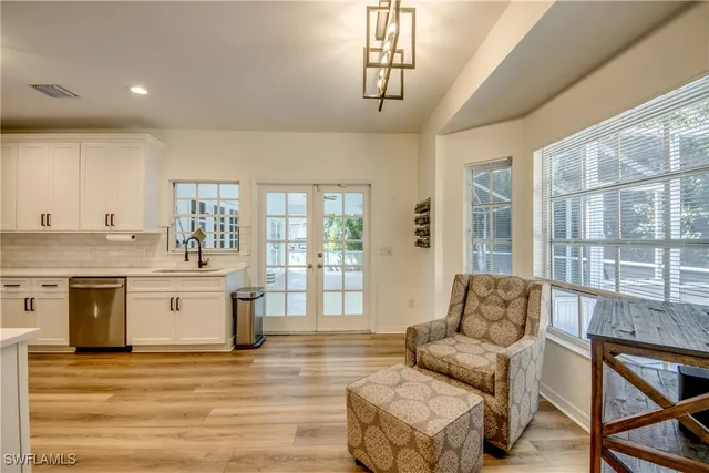 a living room with stainless steel appliances granite countertop furniture and a kitchen view