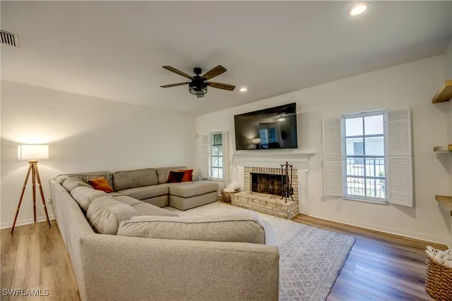 a living room with furniture flat screen tv and a fireplace