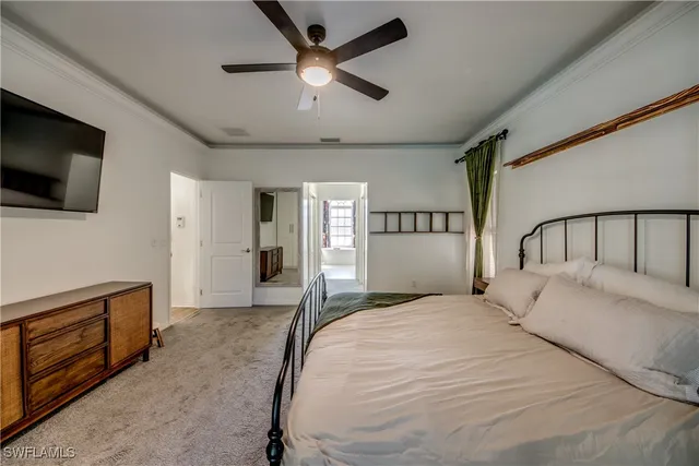 a bedroom with a large bed and a flat screen tv