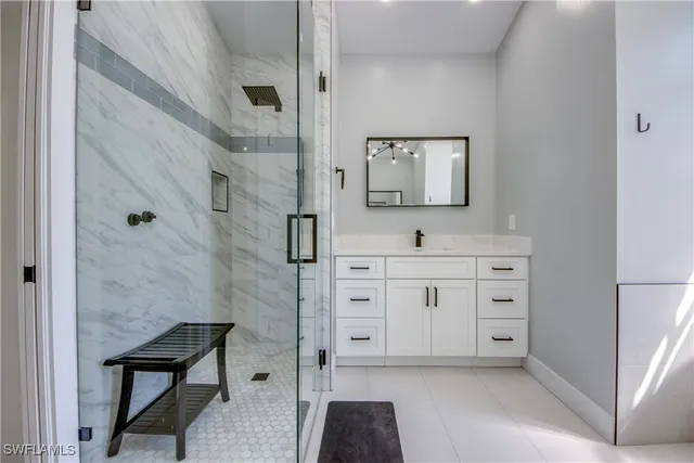 a bathroom with a sink vanity and a mirror