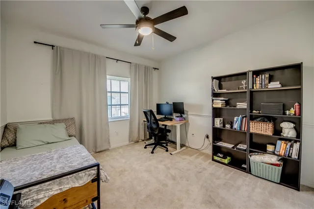 a bedroom that has a bed and a book shelf