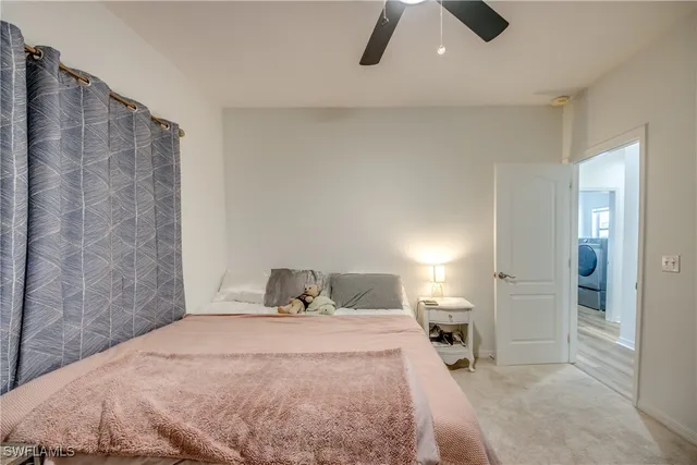 a bedroom with a bed and painting on the wall