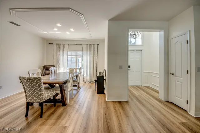 a dining room with furniture and wooden floor
