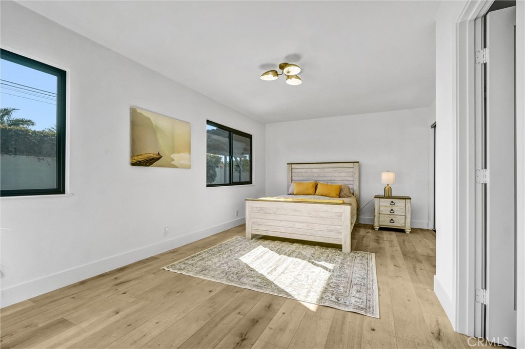 6032 Vane Circle Huntington Beach, CA 92647 - Photo 21 of 56 a bedroom with a bed and a chandelier