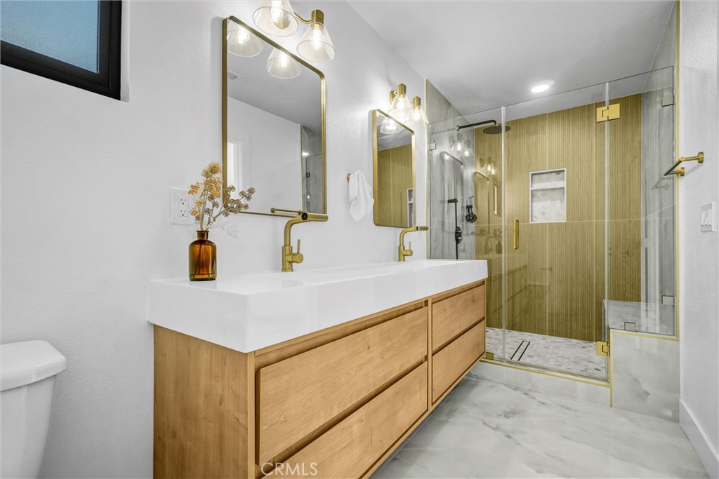 6032 Vane Circle Huntington Beach, CA 92647 - Photo 27 of 56 a bathroom with a sink a mirror and a shower