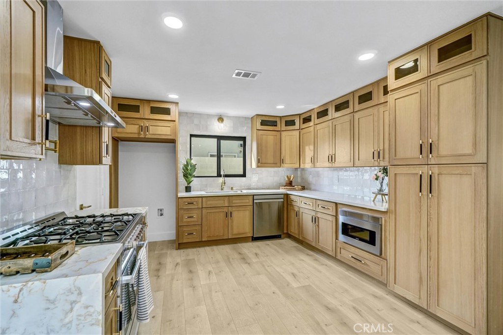 6032 Vane Circle Huntington Beach, CA 92647 - Photo 3 of 56 a kitchen with a stove and a refrigerator