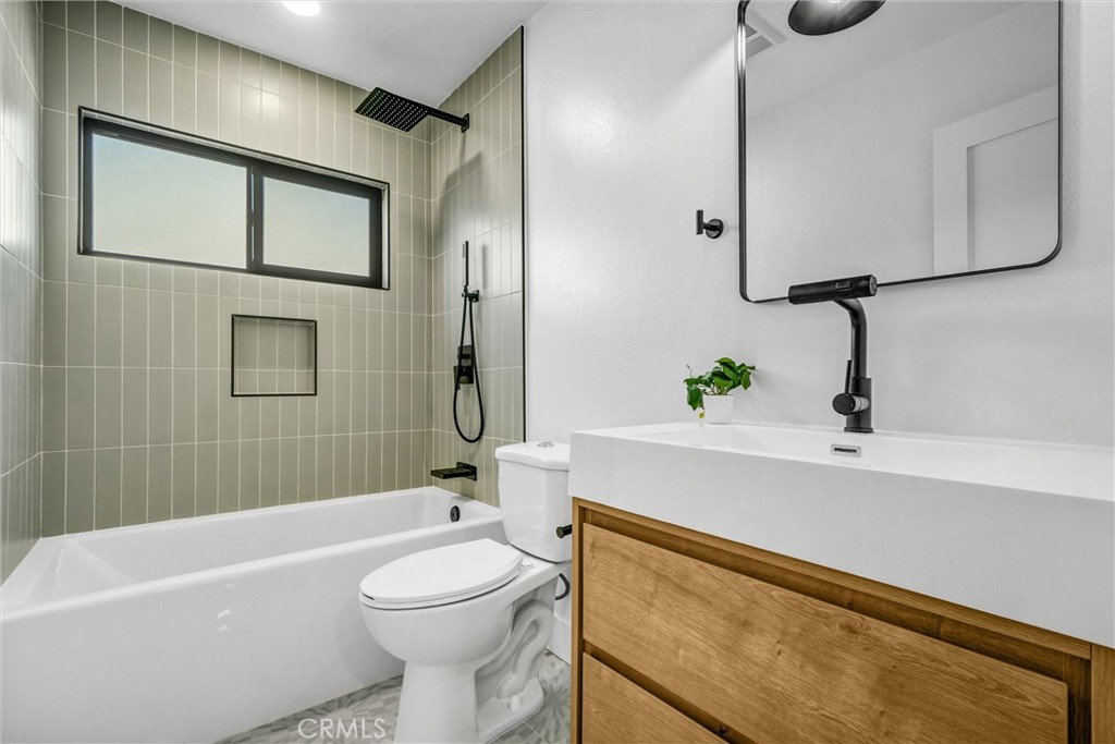 6032 Vane Circle Huntington Beach, CA 92647 - Photo 31 of 56 a bathroom with a sink a toilet and shower