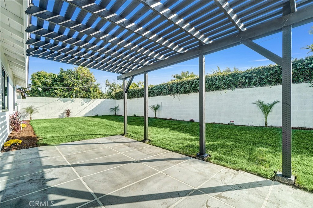 6032 Vane Circle Huntington Beach, CA 92647 - Photo 35 of 56 a view of a backyard with table and chairs under an umbrella