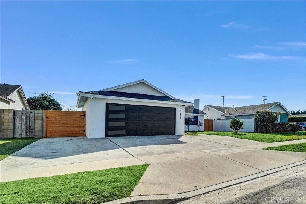 6032 Vane Circle Huntington Beach, CA 92647 - Photo 43 of 56 a front view of a house with a yard and garage