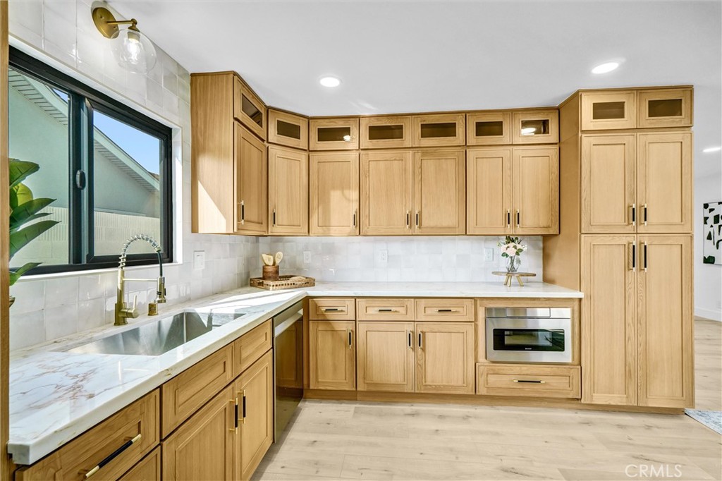 6032 Vane Circle Huntington Beach, CA 92647 - Photo 6 of 56 a kitchen with stainless steel appliances granite countertop a sink and cabinets with wooden floor