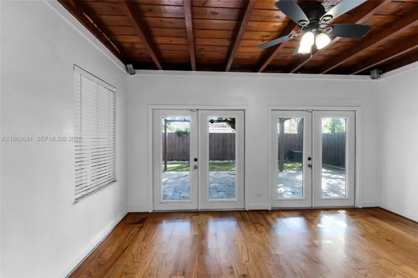 a view of room with window and wooden floor