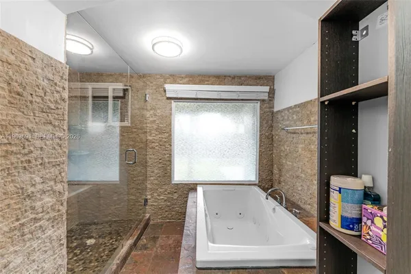 a bathroom with a tub and a shower