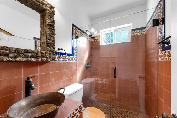 a bathroom with a sink toilet and shower