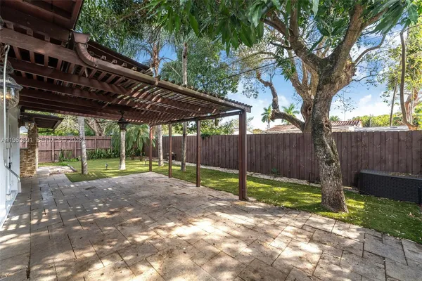 a view of a house with backyard and sitting area
