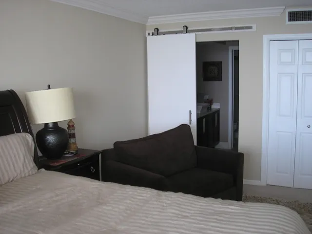 a living room with furniture and a lamp