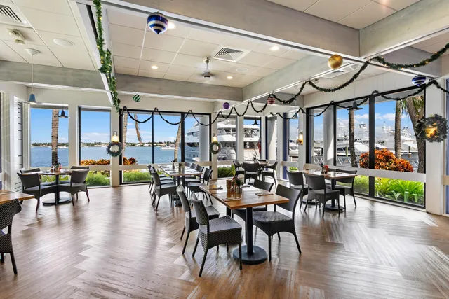a dining hall with lots of furniture and wooden floor