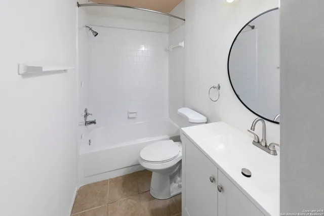 a view of a room with wooden floor and entryway