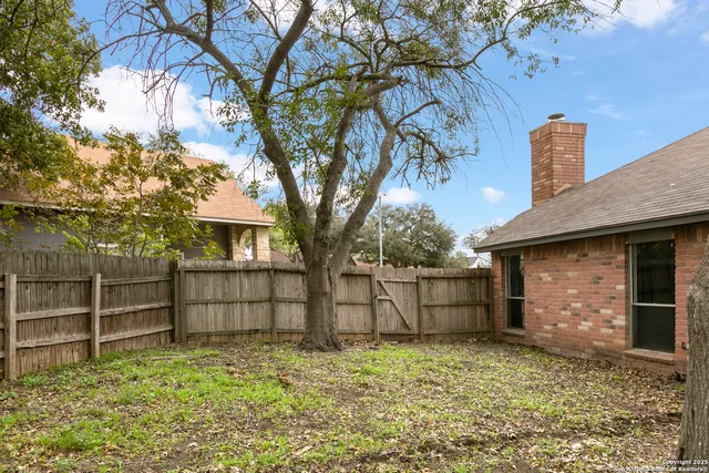 a backyard of a house with yard and outdoor seating