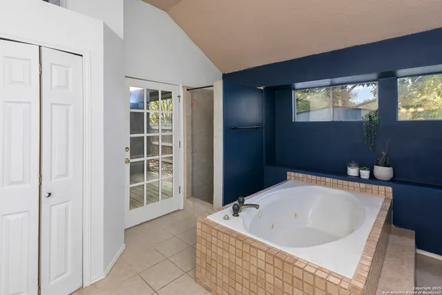 a bath tub sitting in a bathroom next to a window
