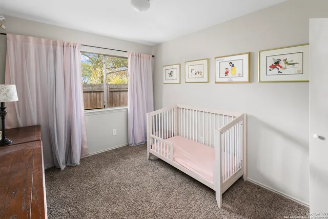 a view of a bedroom with furniture and windows