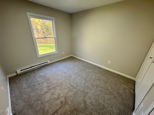 5841 Neff Road Valley City, OH 44280 - Photo 21 of 24 Spare room with baseboard heating and dark colored carpet