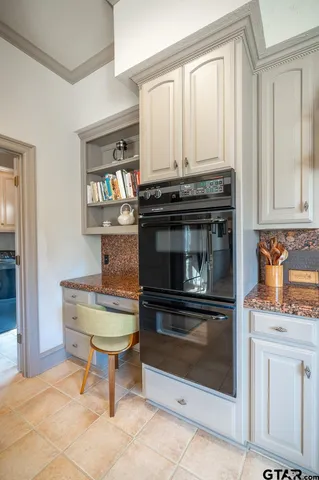 a stove top oven sitting inside of a kitchen