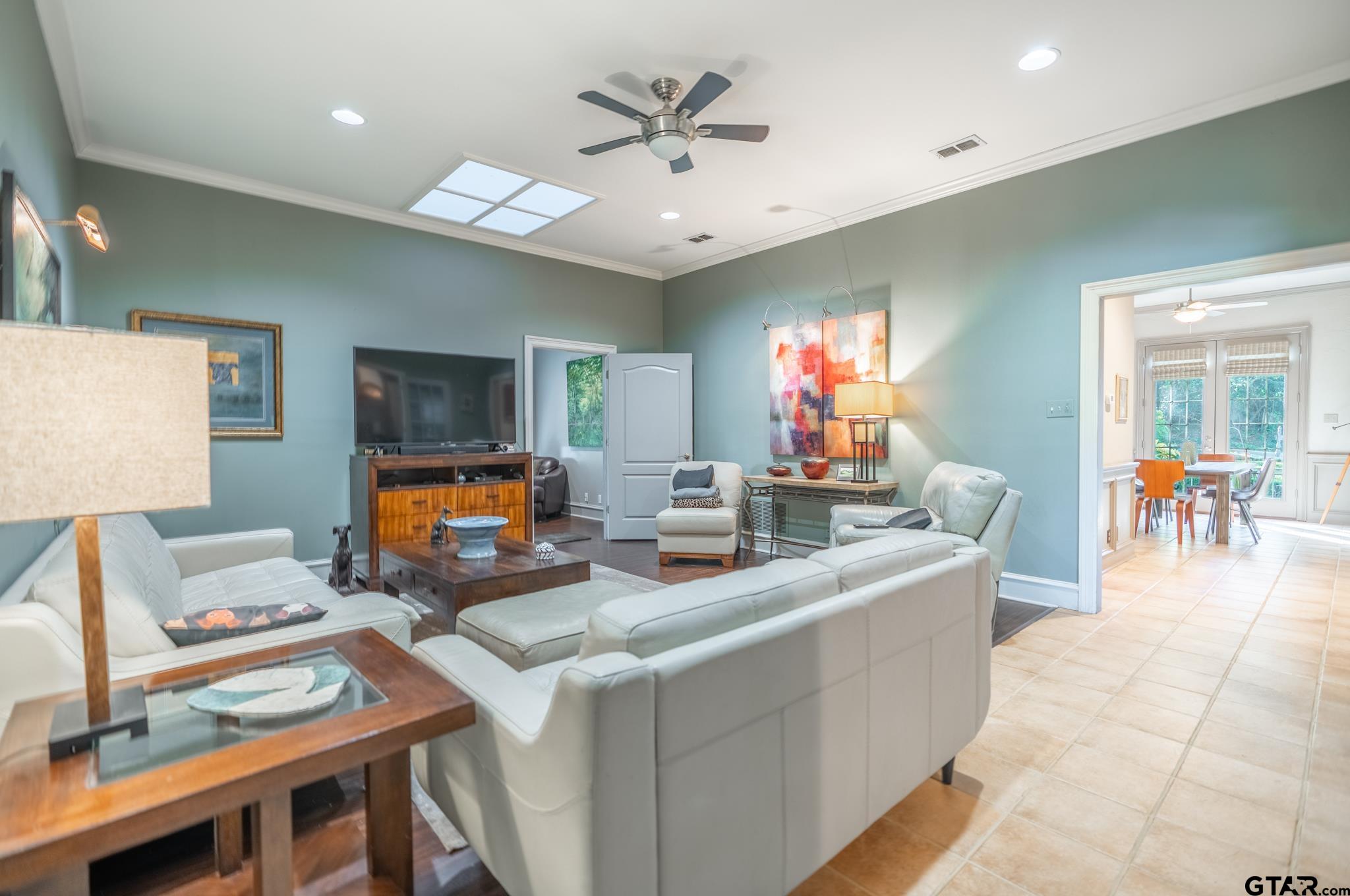 1520 Clubview Drive Tyler, TX 75701 - Photo 20 of 48 a living room with furniture a chandelier and a flat screen tv