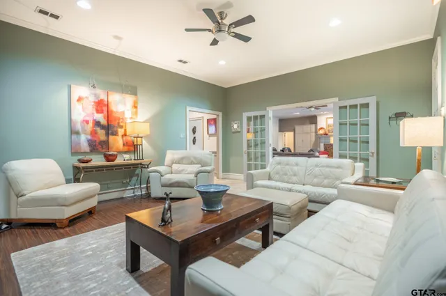 a living room with furniture a rug and a chandelier