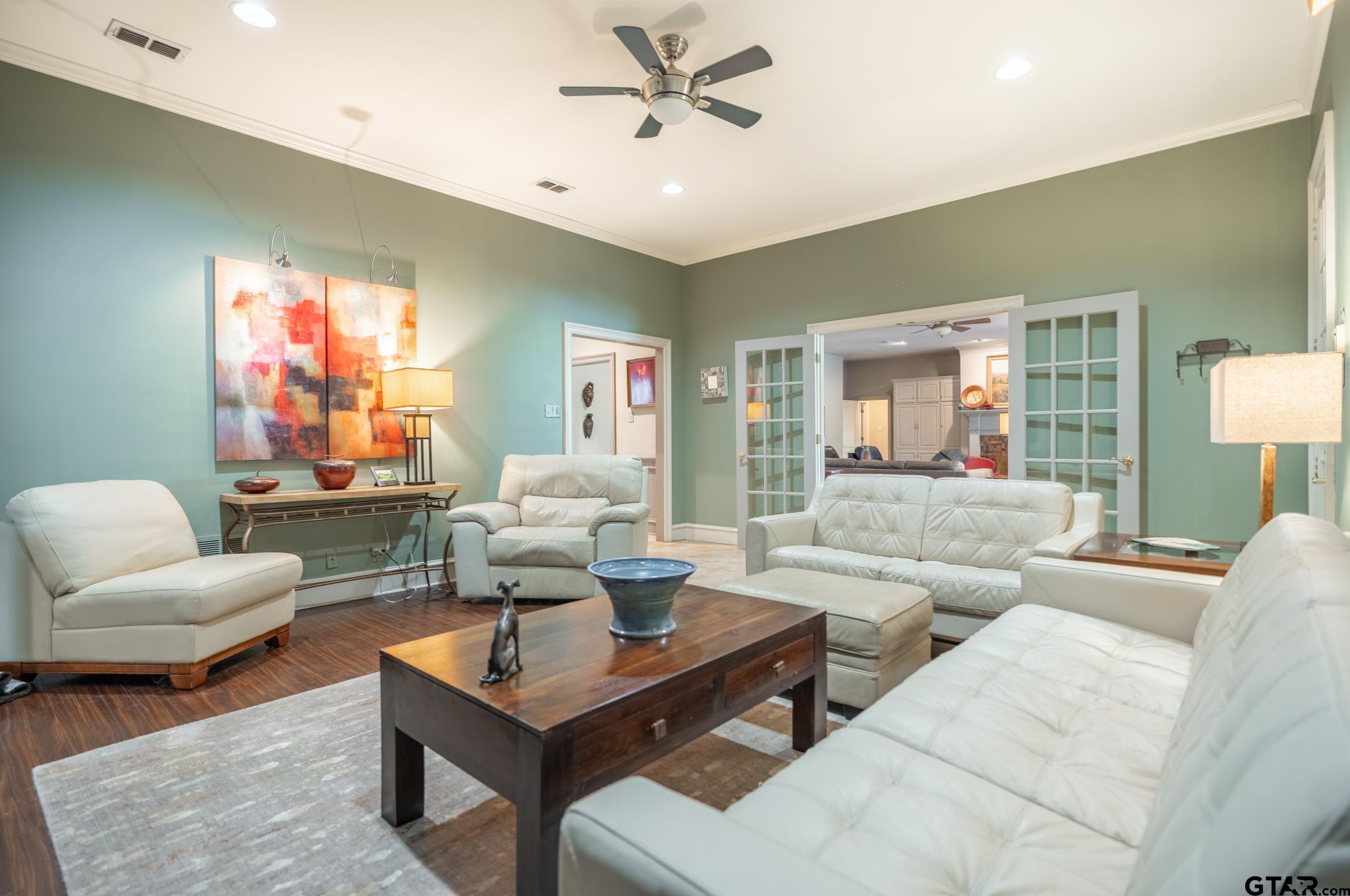 1520 Clubview Drive Tyler, TX 75701 - Photo 21 of 48 a living room with furniture a rug and a chandelier