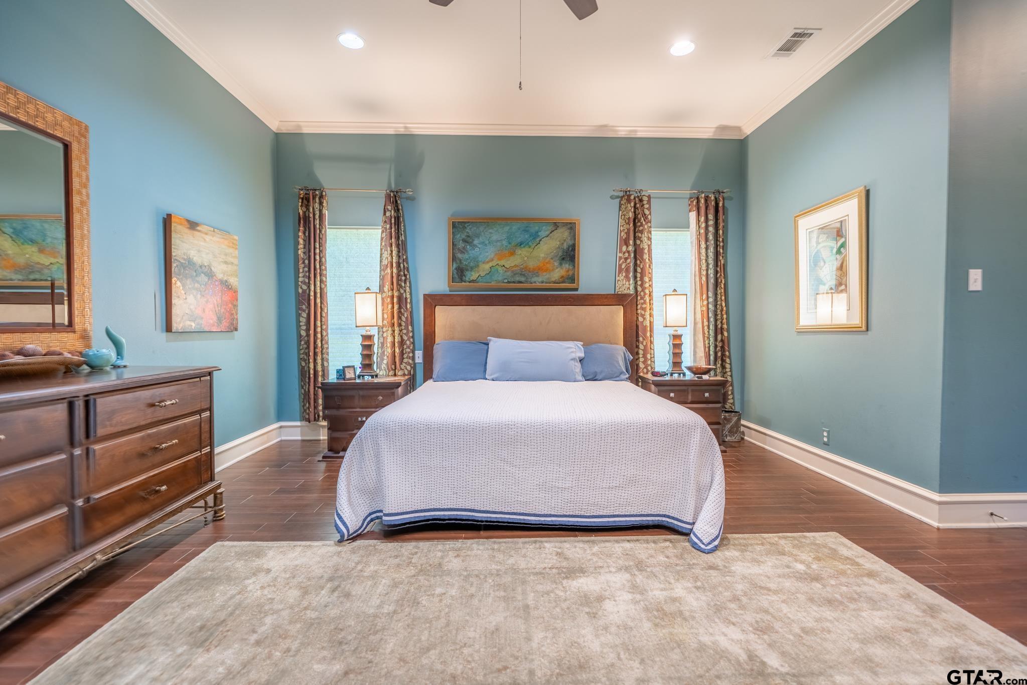 1520 Clubview Drive Tyler, TX 75701 - Photo 24 of 48 a bedroom with a bed and dresser with mirror