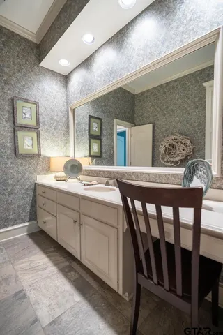 a spacious bathroom with a granite countertop sink a mirror and a