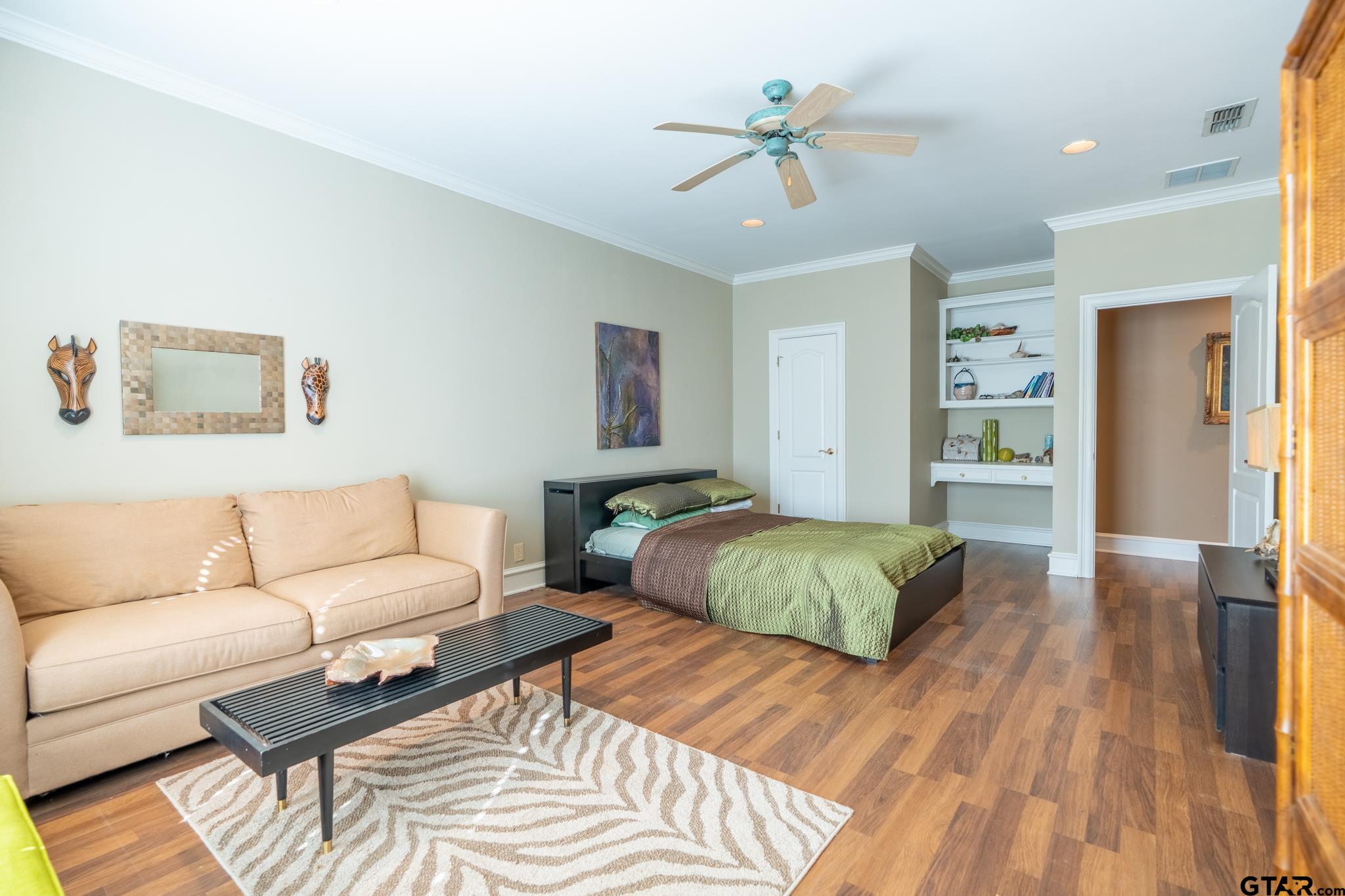 1520 Clubview Drive Tyler, TX 75701 - Photo 34 of 48 a spacious bedroom with a bed and a couch