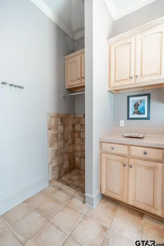a bathroom with a granite countertop sink and cabinets