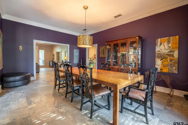 a dining room with furniture a chandelier and window