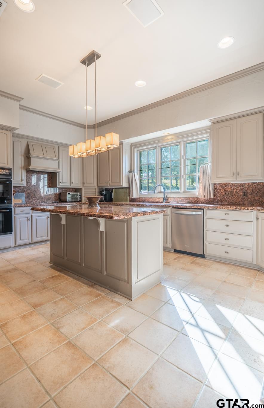 1520 Clubview Drive Tyler, TX 75701 - Photo 10 of 48 a kitchen with stainless steel appliances granite countertop a stove top oven a sink a counter top space cabinets and a window