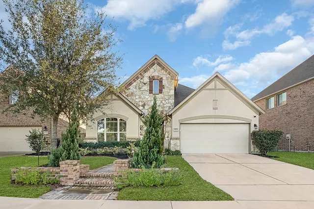 a front view of a house with a yard and garage