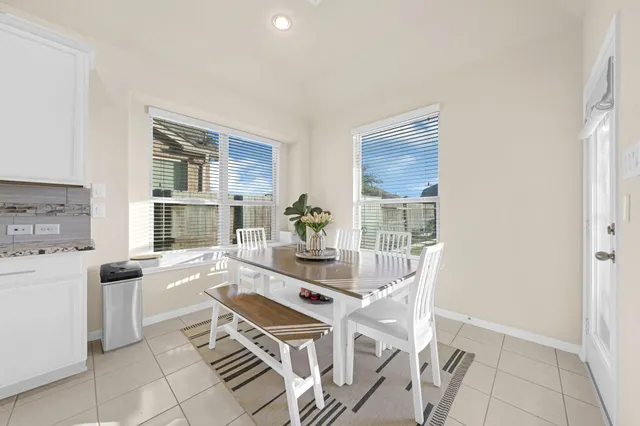 a dining room with furniture and a kitchen view
