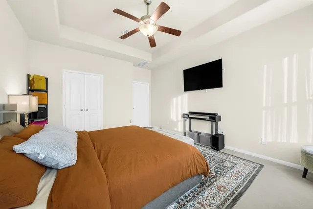 a bedroom with a bed and a television