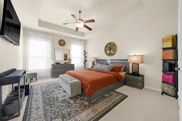 a bedroom with a bed and flat screen tv